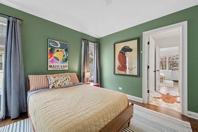 bedroom featuring wood finished floors and baseboards