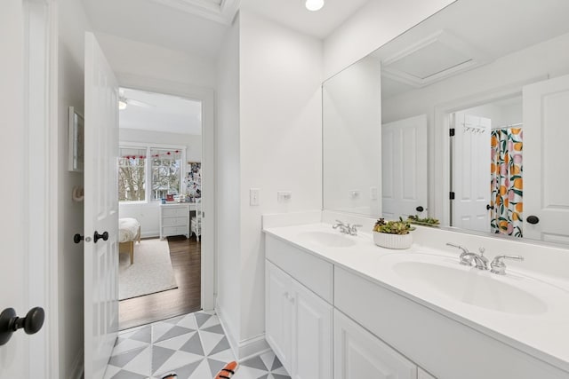 bathroom featuring a sink, ensuite bathroom, tile patterned floors, and double vanity