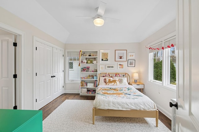 bedroom featuring lofted ceiling, ceiling fan, baseboards, and wood finished floors