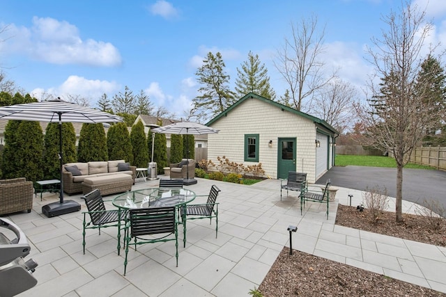 view of patio / terrace featuring an outbuilding, fence, and an outdoor hangout area