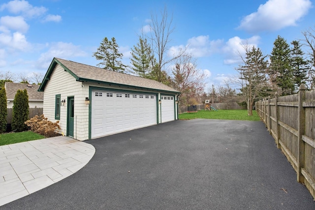 detached garage featuring fence