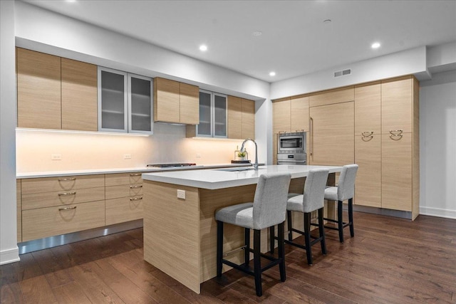1560 Oakwood Ave Unit 205, Highland Park, IL 60035 - kitchen with a breakfast bar area, appliances with stainless steel finishes, dark wood-style flooring, and a sink
