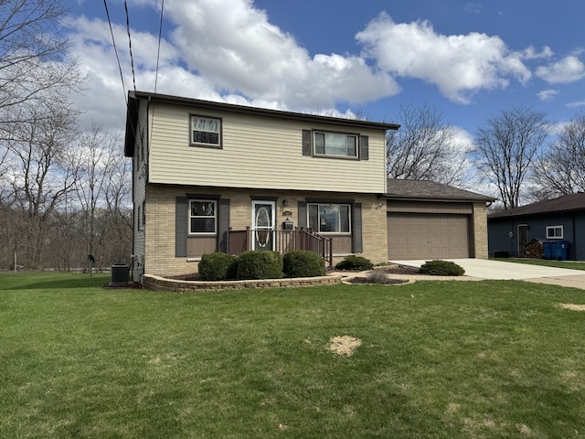1409 Plain St, Peru, IL 61354 - colonial home featuring a garage, driveway, a front yard, and brick siding