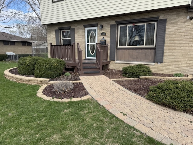 1409 Plain St, Peru, IL 61354 - property entrance featuring brick siding and a yard