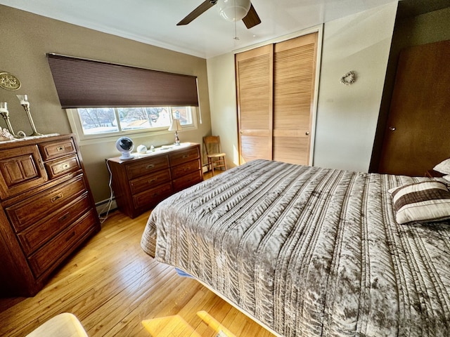 1409 Plain St, Peru, IL 61354 - bedroom with light wood-style floors, a closet, baseboard heating, and ceiling fan