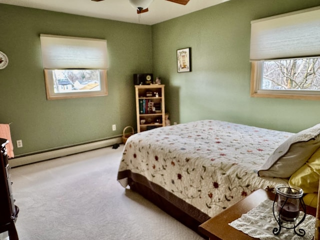 1409 Plain St, Peru, IL 61354 - carpeted bedroom with a baseboard radiator and ceiling fan