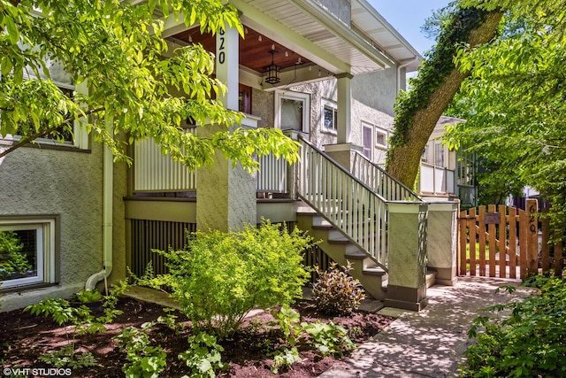 620 S Scoville Ave, Oak Park, IL 60304 - view of side of property with fence, stairs, and stucco siding