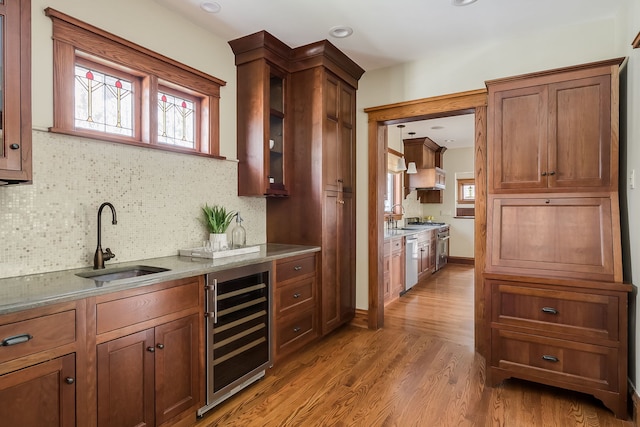 620 S Scoville Ave, Oak Park, IL 60304 - bar featuring wine cooler, wood finished floors, stainless steel dishwasher, a sink, and tasteful backsplash