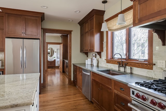 620 S Scoville Ave, Oak Park, IL 60304 - kitchen with tasteful backsplash, hanging light fixtures, a sink, light wood-style floors, and appliances with stainless steel finishes