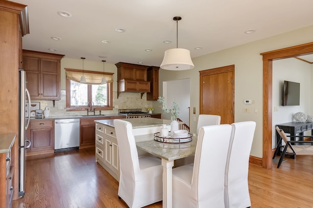 620 S Scoville Ave, Oak Park, IL 60304 - kitchen featuring tasteful backsplash, appliances with stainless steel finishes, a center island, and a sink
