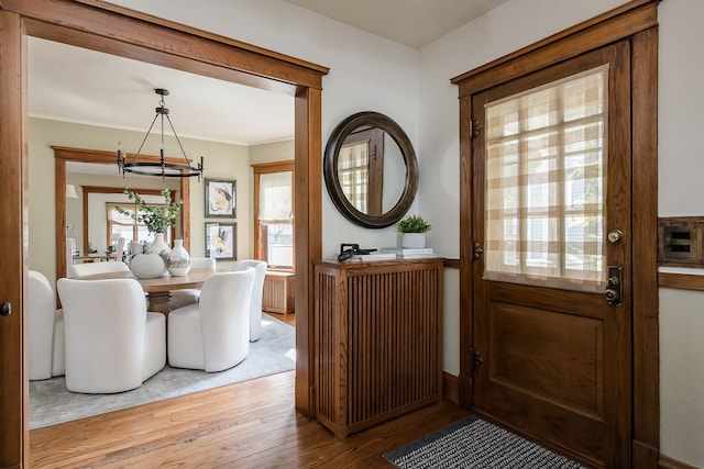 620 S Scoville Ave, Oak Park, IL 60304 - foyer entrance with a chandelier, wood finished floors, and ornamental molding