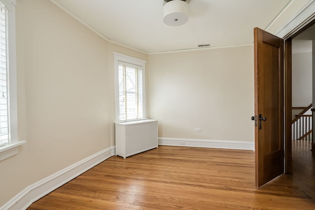 620 S Scoville Ave, Oak Park, IL 60304 - unfurnished room with light wood-style floors, a wealth of natural light, crown molding, and visible vents