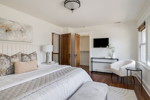 620 S Scoville Ave, Oak Park, IL 60304 - bedroom with dark wood finished floors, baseboards, visible vents, a spacious closet, and a closet