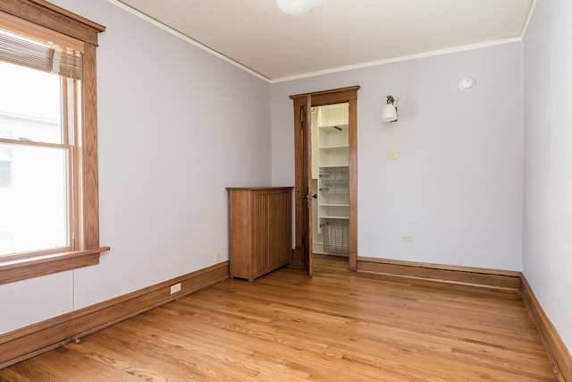 620 S Scoville Ave, Oak Park, IL 60304 - empty room with light wood-style floors, plenty of natural light, and ornamental molding