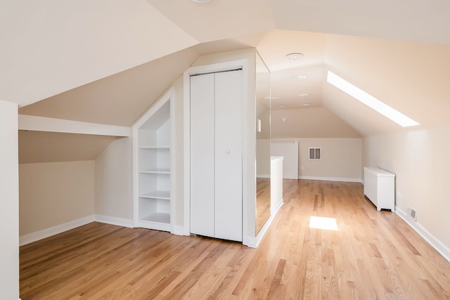 620 S Scoville Ave, Oak Park, IL 60304 - bonus room with baseboards, light wood-style flooring, visible vents, and lofted ceiling with skylight