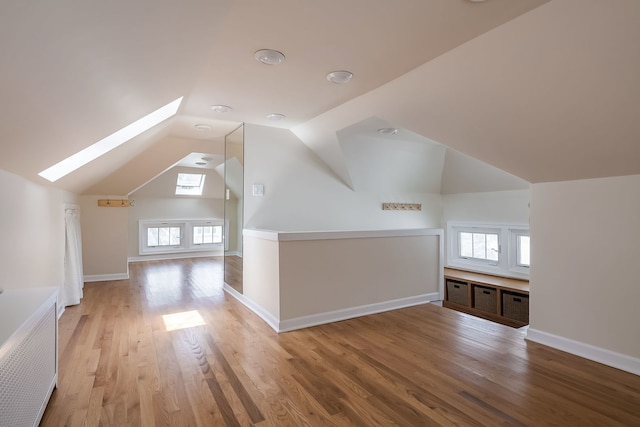 620 S Scoville Ave, Oak Park, IL 60304 - additional living space featuring plenty of natural light, baseboards, light wood-style floors, and vaulted ceiling with skylight