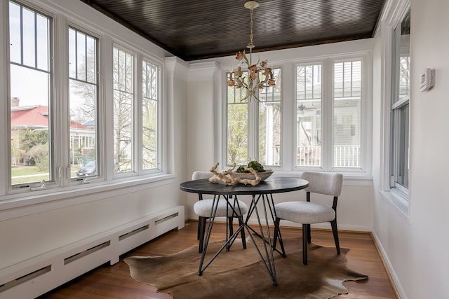 620 S Scoville Ave, Oak Park, IL 60304 - sunroom featuring baseboard heating, a healthy amount of sunlight, and a chandelier