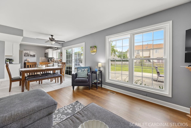 2690 Moss Ln, Aurora, IL 60504 - living room featuring baseboards, a ceiling fan, and light wood-style floors