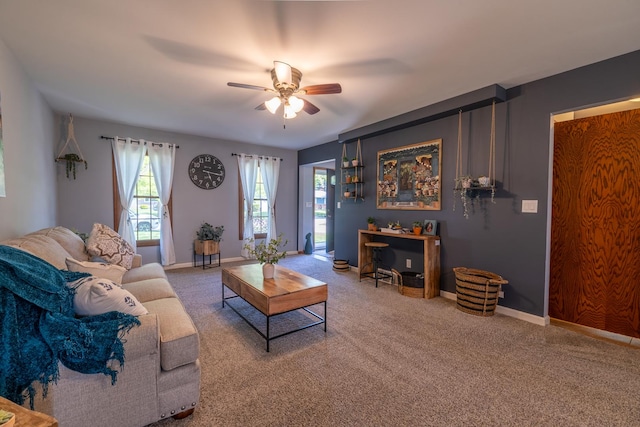 living area with ceiling fan, healthy amount of natural light, and carpet flooring