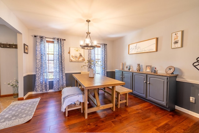 dining space with a chandelier, healthy amount of natural light, and dark wood-style floors