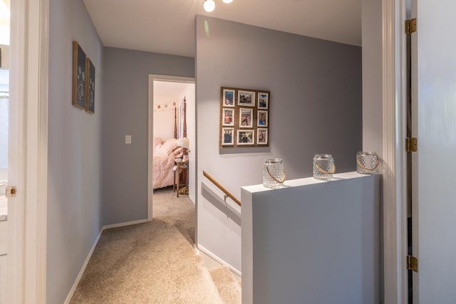 corridor with carpet and baseboards