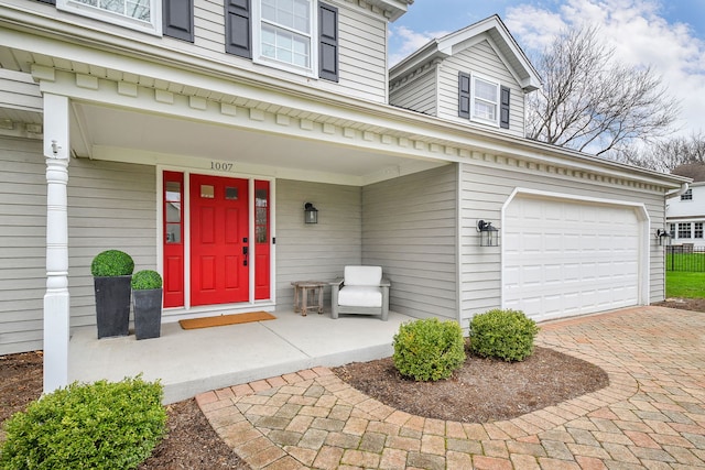 1007 Canonero Dr, Naperville, IL 60540 - entrance to property featuring an attached garage, covered porch, and decorative driveway