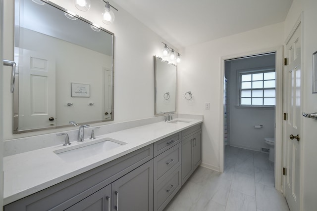 1007 Canonero Dr, Naperville, IL 60540 - full bathroom with toilet, double vanity, marble finish floor, and a sink