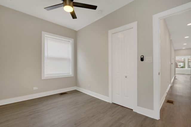 8742 S Justine St, Chicago, IL 60620 - unfurnished room with visible vents, baseboards, a ceiling fan, and wood finished floors