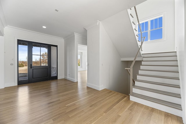 entrance foyer featuring baseboards, recessed lighting, stairway, light wood-style flooring, and crown molding