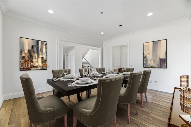 dining area with stairway, crown molding, and wood finished floors