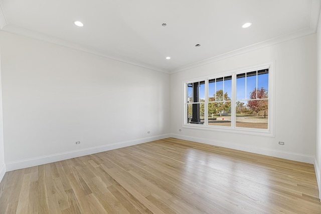 empty room featuring crown molding, recessed lighting, baseboards, and light wood-style floors