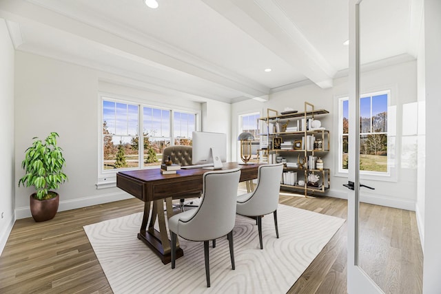 office space with crown molding, beamed ceiling, plenty of natural light, and wood finished floors