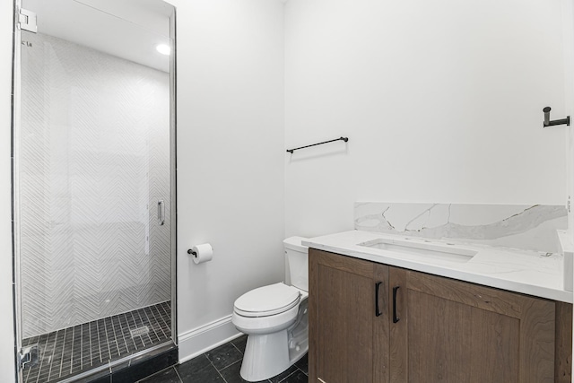 bathroom featuring baseboards, toilet, vanity, tile patterned flooring, and a stall shower