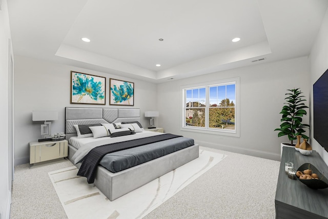 carpeted bedroom featuring a raised ceiling, baseboards, and recessed lighting