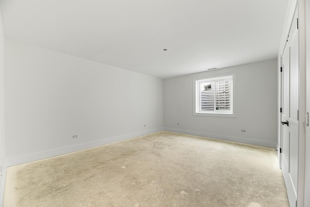 unfurnished bedroom featuring concrete floors and baseboards