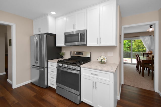 1603 Aurora Way, Normal, IL 61761 - kitchen with appliances with stainless steel finishes, dark wood finished floors, baseboards, white cabinetry, and light stone counters
