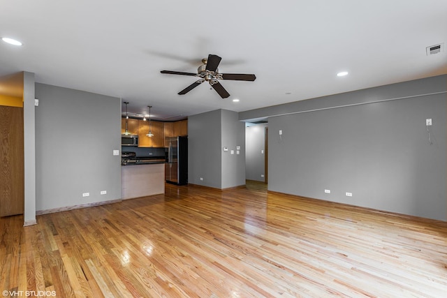 unfurnished living room with recessed lighting, visible vents, light wood-type flooring, and a ceiling fan