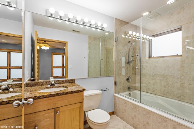 full bath featuring visible vents, toilet, vanity, tile patterned floors, and tiled shower / bath