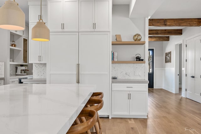 kitchen featuring light wood-style floors, decorative backsplash, open shelves, and white cabinets