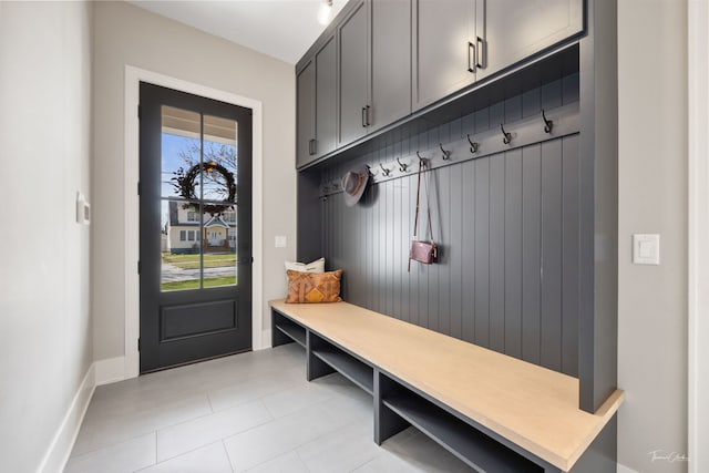mudroom featuring baseboards and light tile patterned flooring