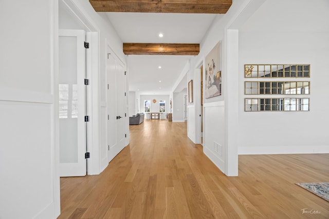 hall with visible vents, beam ceiling, baseboards, light wood finished floors, and recessed lighting