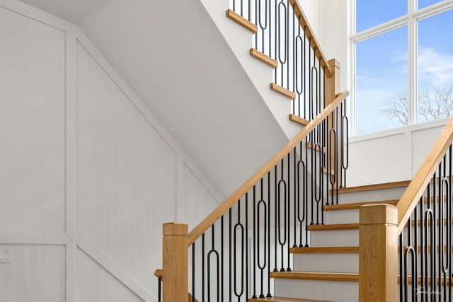stairs featuring high vaulted ceiling