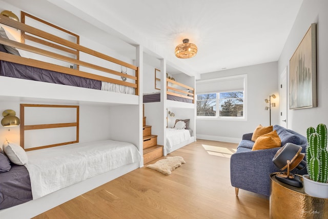 bedroom with baseboards and wood finished floors
