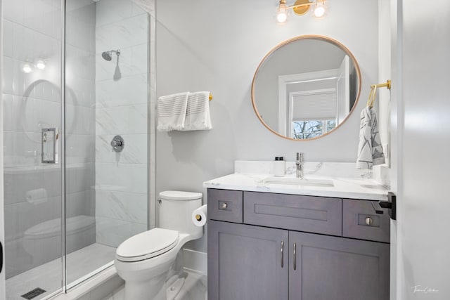bathroom featuring vanity, toilet, and a stall shower