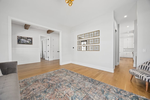 living room with baseboards, recessed lighting, and wood finished floors