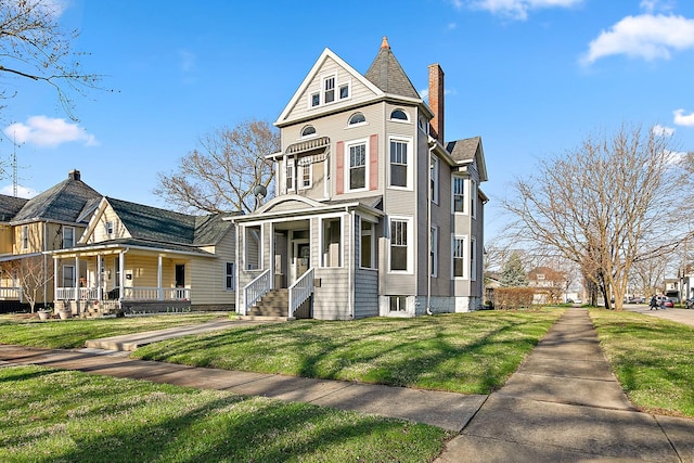 505 S Indiana Ave, Kankakee, IL 60901 - victorian-style house with a front yard, a chimney, and covered porch