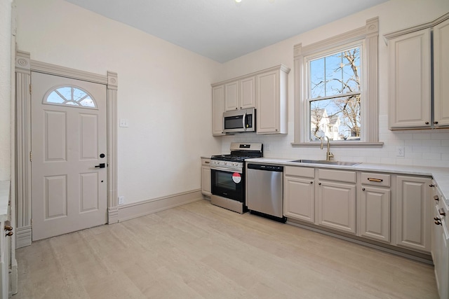 505 S Indiana Ave, Kankakee, IL 60901 - kitchen with tasteful backsplash, light countertops, appliances with stainless steel finishes, light wood finished floors, and a sink