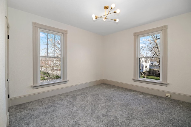 505 S Indiana Ave, Kankakee, IL 60901 - empty room featuring carpet, baseboards, an inviting chandelier, and a healthy amount of sunlight