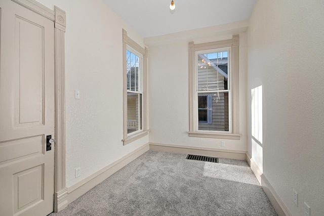 505 S Indiana Ave, Kankakee, IL 60901 - spare room with a textured wall, visible vents, baseboards, and carpet floors
