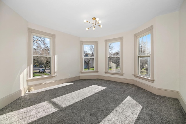 505 S Indiana Ave, Kankakee, IL 60901 - unfurnished dining area with a notable chandelier, baseboards, and carpet floors